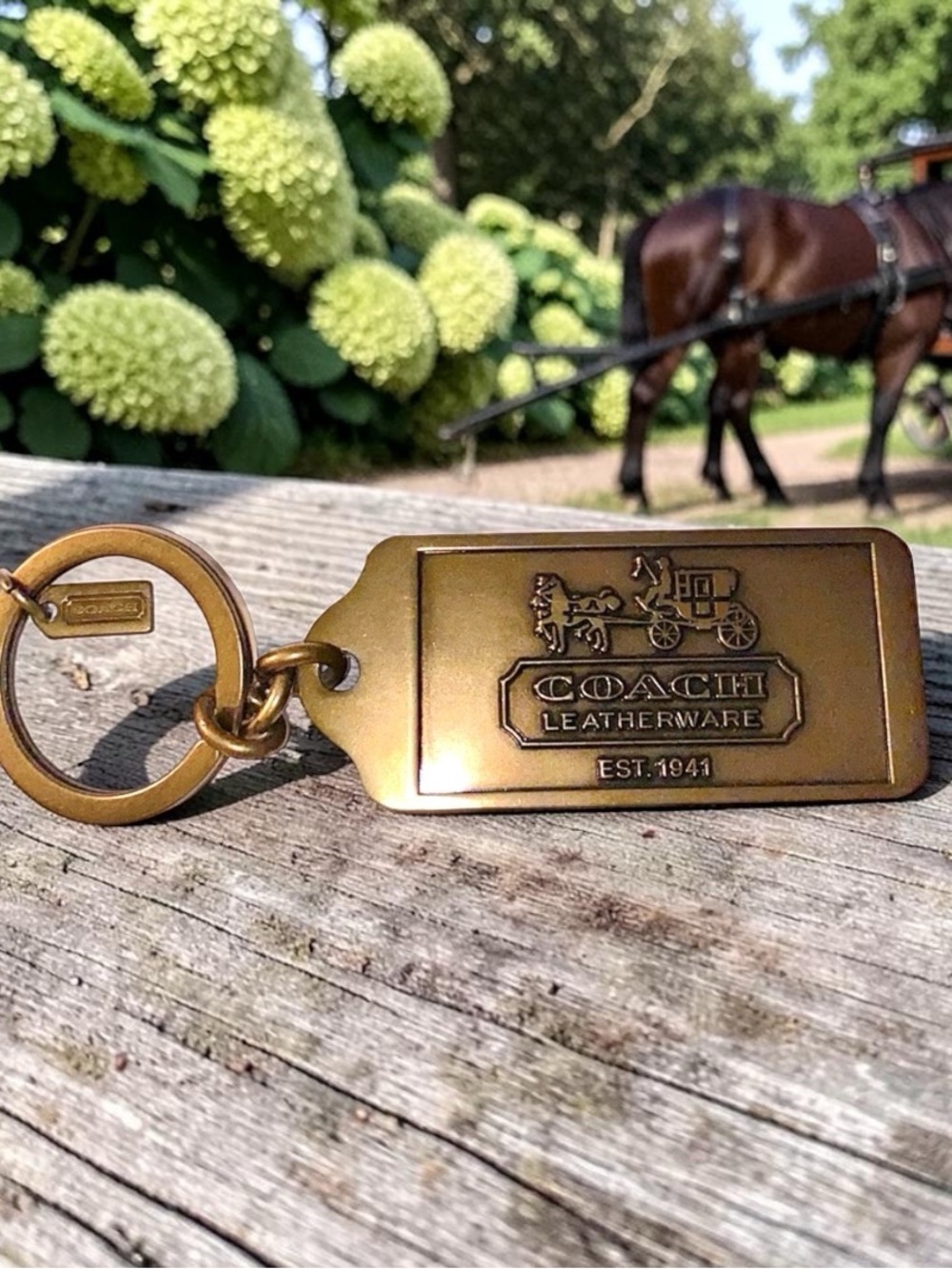 Coach brass keychain stamped Coach leatherware horse and carriage
